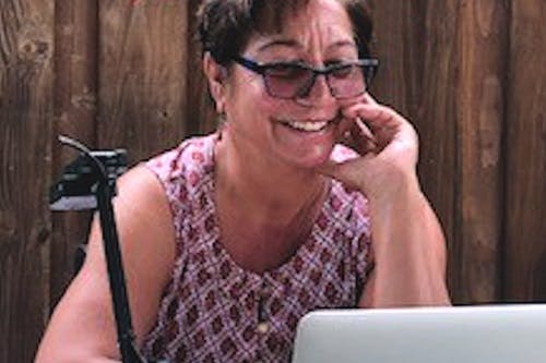 Smiling woman wearing sunglasses and talking on phone