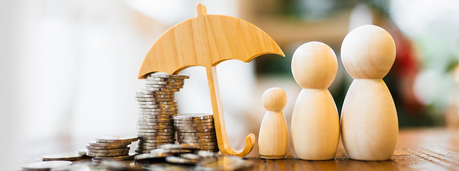 The image features wooden figurines of a family under an umbrella, with stacks of coins, symbolizing financial protection and security.