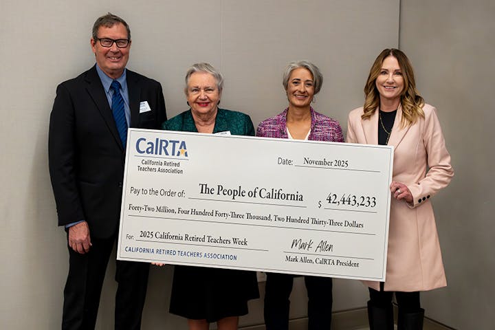 A group holds a large check from the California Retired Teachers Association for over $42 million for "The People of California."