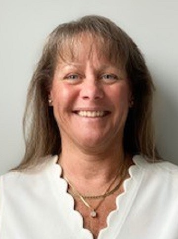 Stephanie Henry has long hair, wears a white shirt.