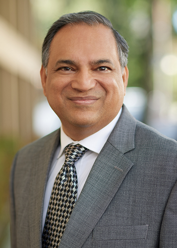 Chief Technology Officer Ashish Jain wears a blazer and white shirt and tie