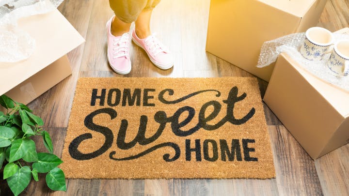 Home sweet home welcome mat with moving boxes