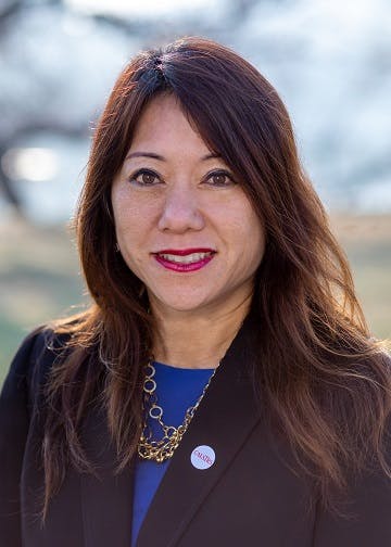 State Treasurer Fiona Ma has long brown hair, wears a jacket and blue shirt.