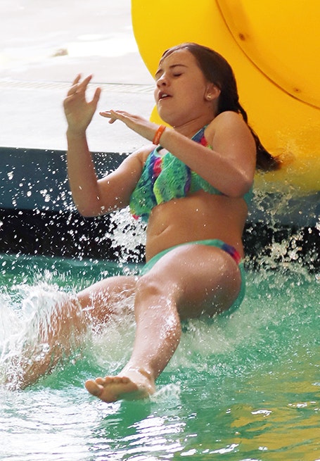 Girl going down pool slide