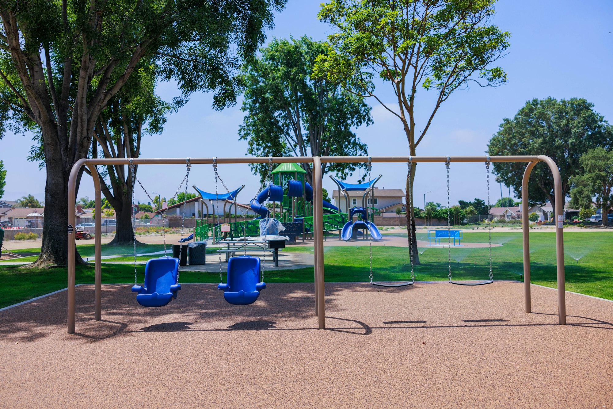 May contain: outdoor play area, outdoors, play area, grass, nature, park, plant, chair, furniture, desk, table, person, car, transportation, and vehicle