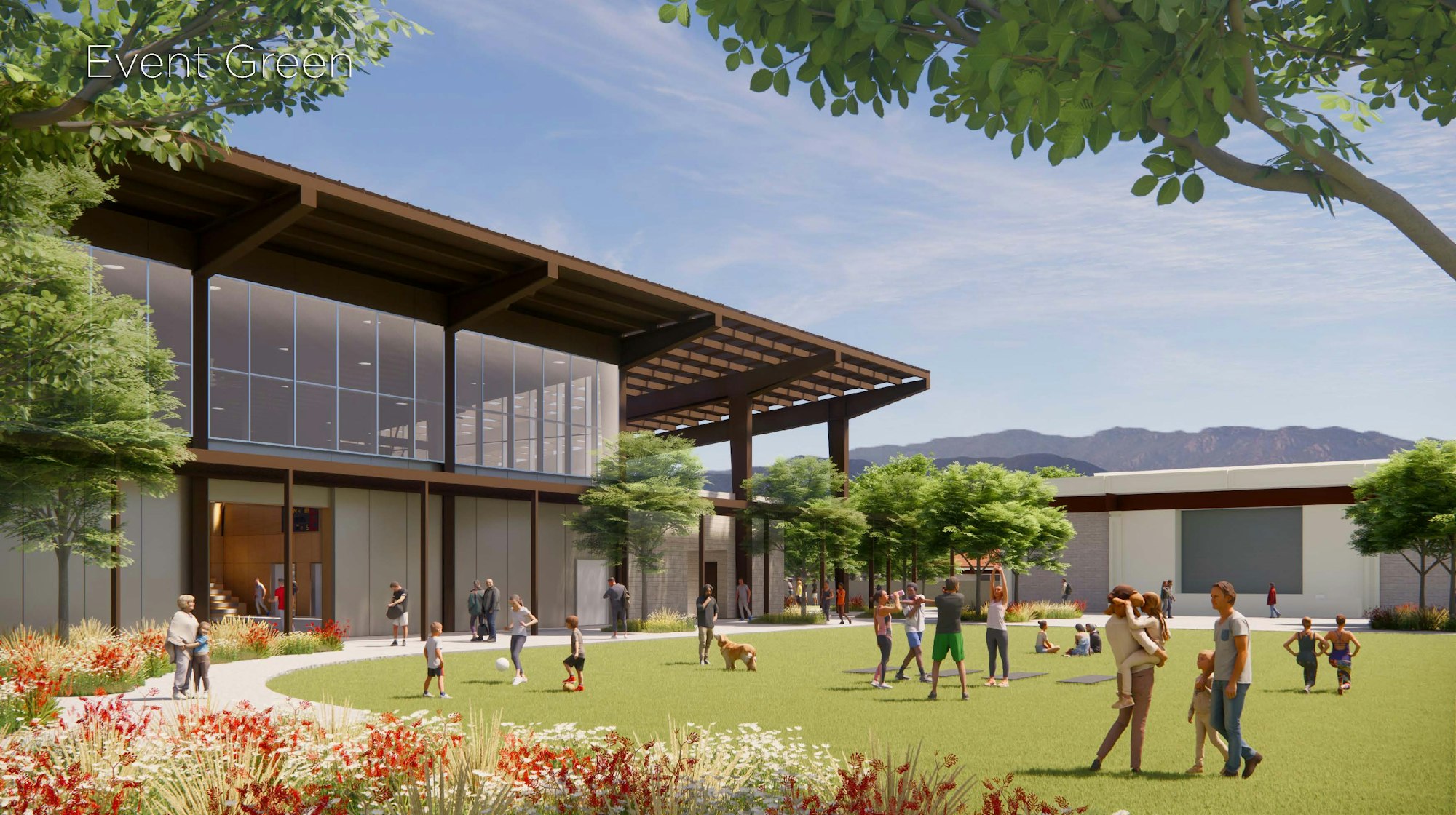 A vibrant outdoor event space with people engaging in activities, surrounded by greenery and modern architecture.