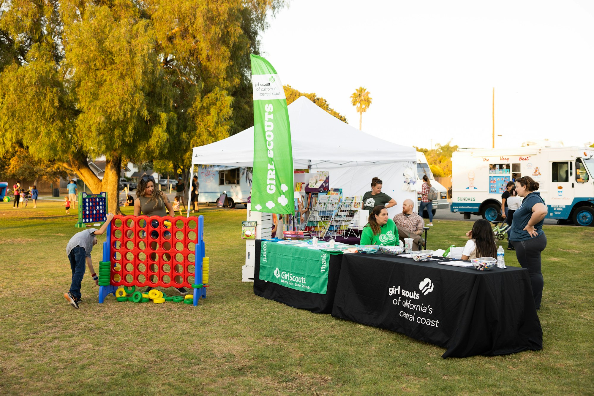 May contain: person, grass, plant, clothing, footwear, shoe, transportation, truck, vehicle, tent, and people