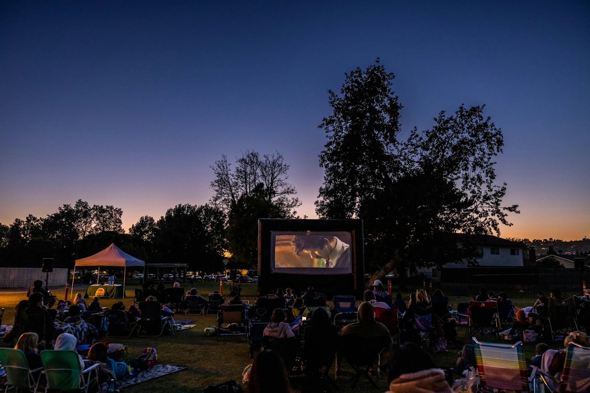 May contain: concert, crowd, person, people, tent, electronics, screen, accessories, bag, and handbag