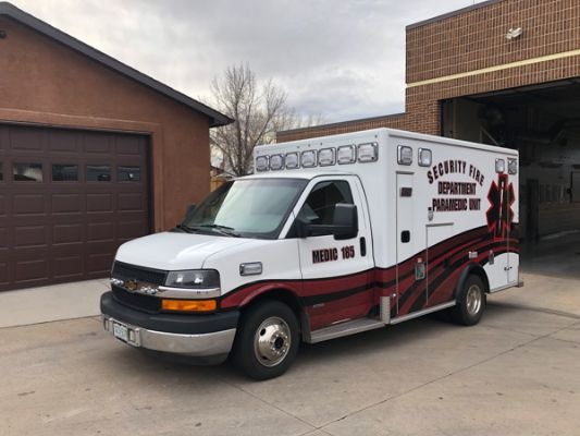An ambulance from the Security Fire Department's Paramedic Unit parked outside a building.