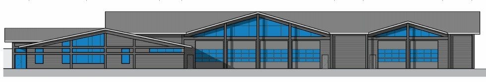 A building with three peaked roofs, large blue windows, and multiple garage doors.
