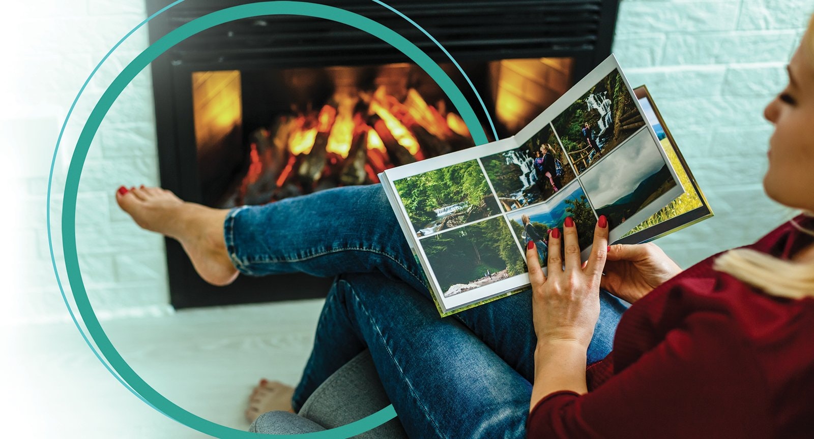 Person relaxing by a fireplace, reading a photo book with outdoor images.