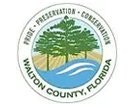Seal of Walton County, Florida with trees and a river, featuring the words "Pride, Preservation, Conservation."