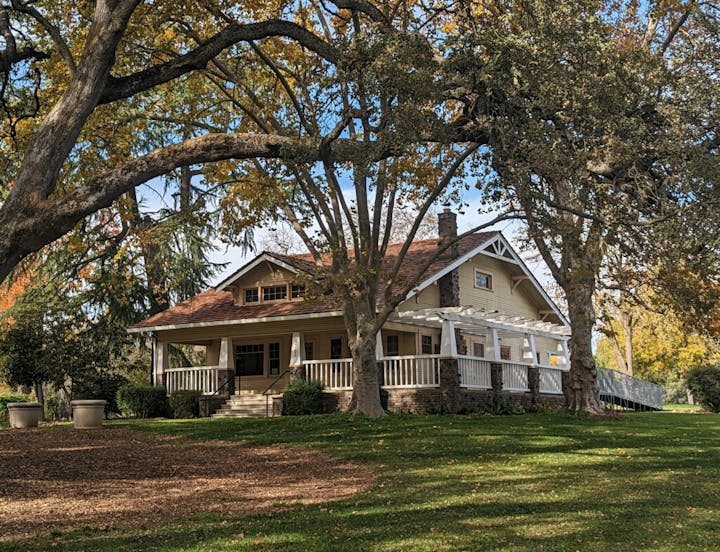 May contain: architecture, building, cottage, house, housing, grass, plant, and tree