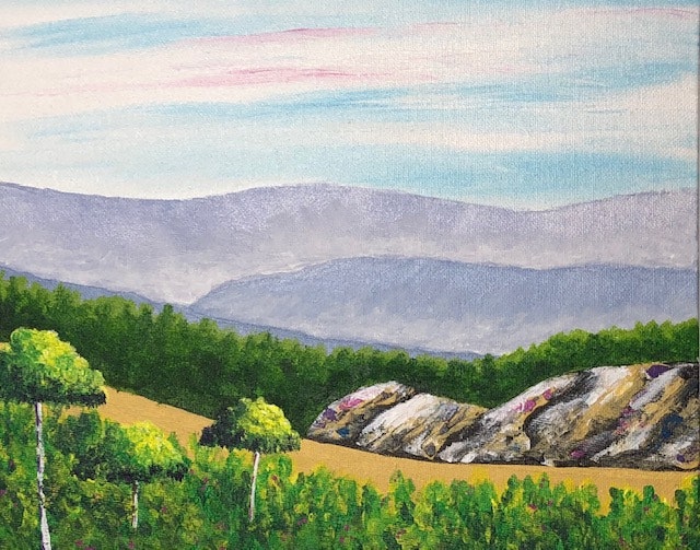 A scenic landscape with rolling hills, distant mountains, a forest, and a bright sky.