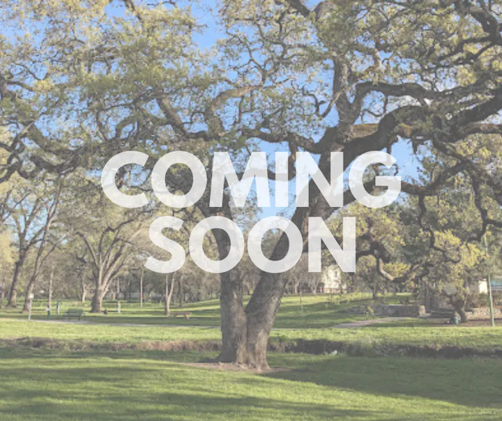 Trees and grass in a park with the text "COMING SOON" overlaying the image.