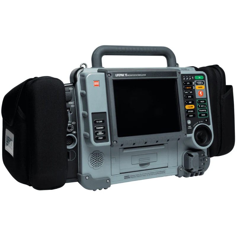 A portable defibrillator with a screen and various buttons, used for monitoring and resuscitation in medical emergencies.