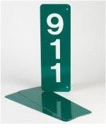 A green sign with white numbers "911" on it.