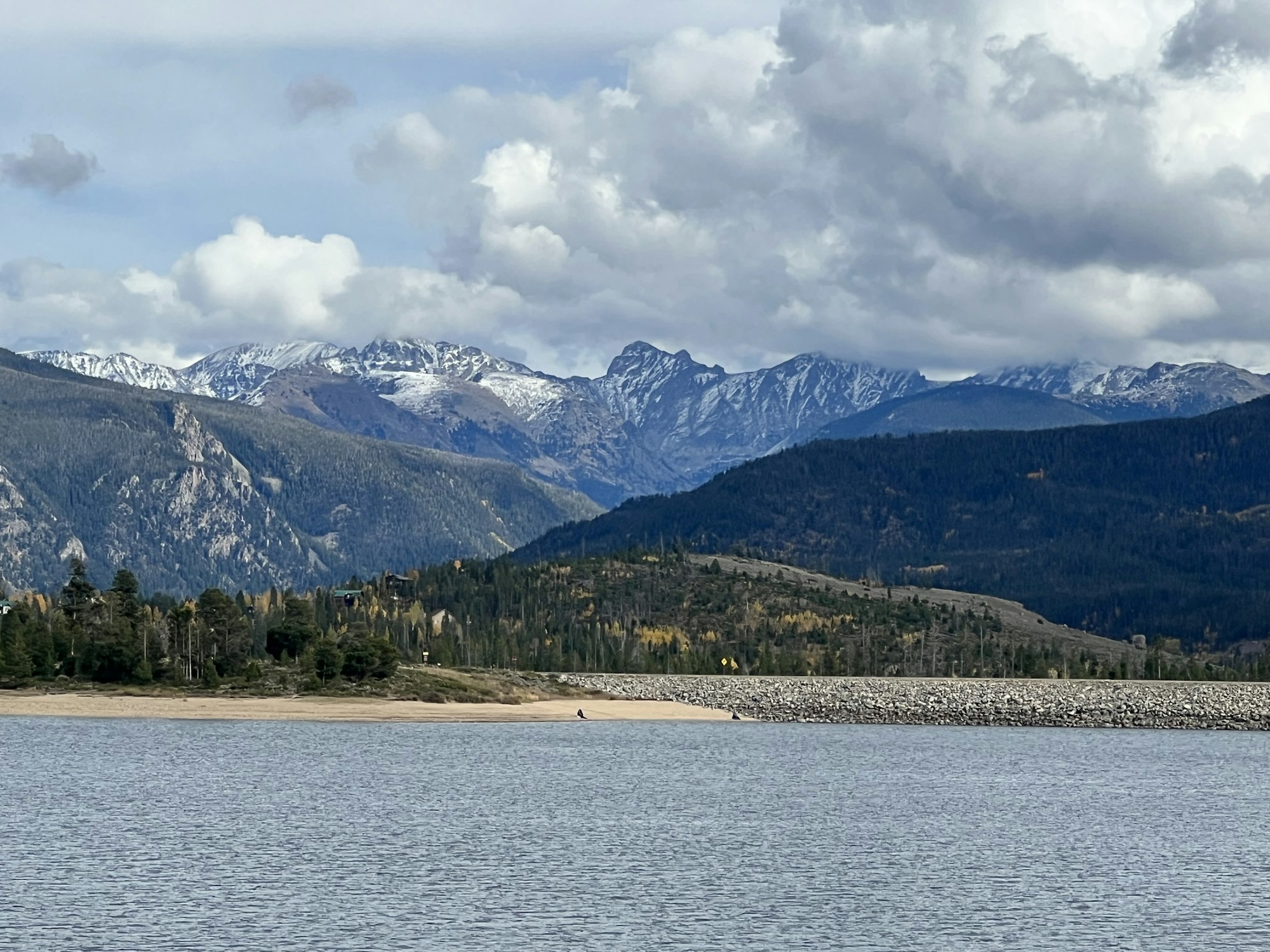 May contain: nature, outdoors, mountain, mountain range, lake, water, scenery, plant, tree, cloud, cumulus, sky, weather, fir, and peak