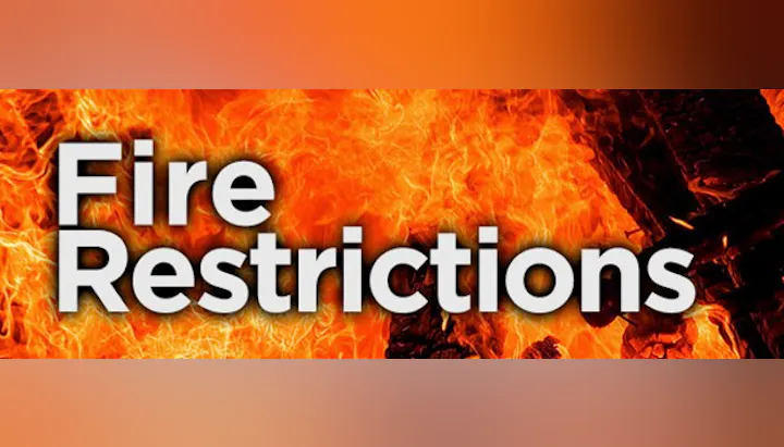 Text "Fire Restrictions" over a background of flames.