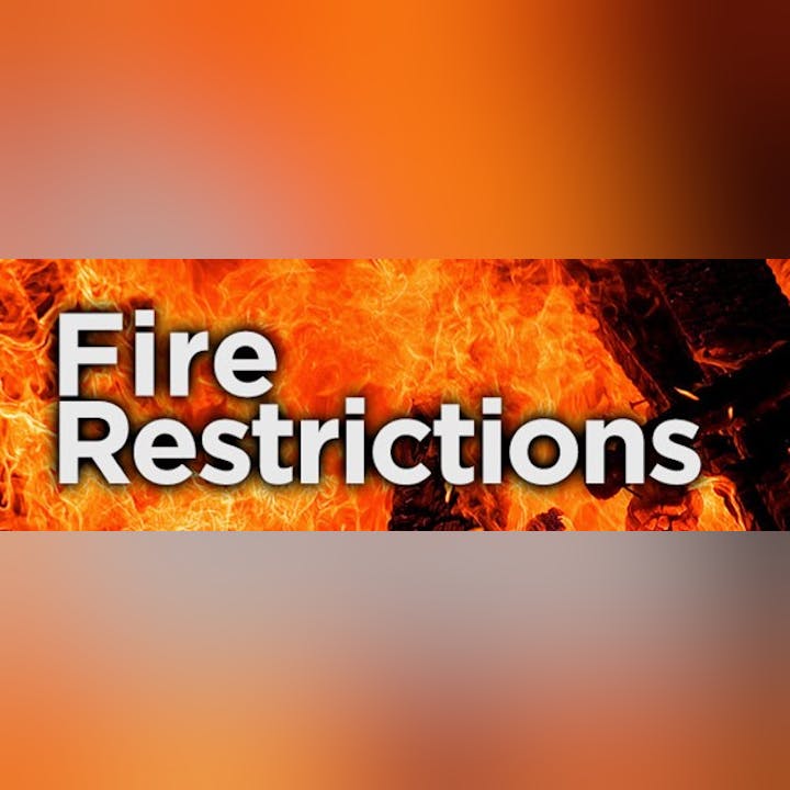 Text "Fire Restrictions" over a background of flames.