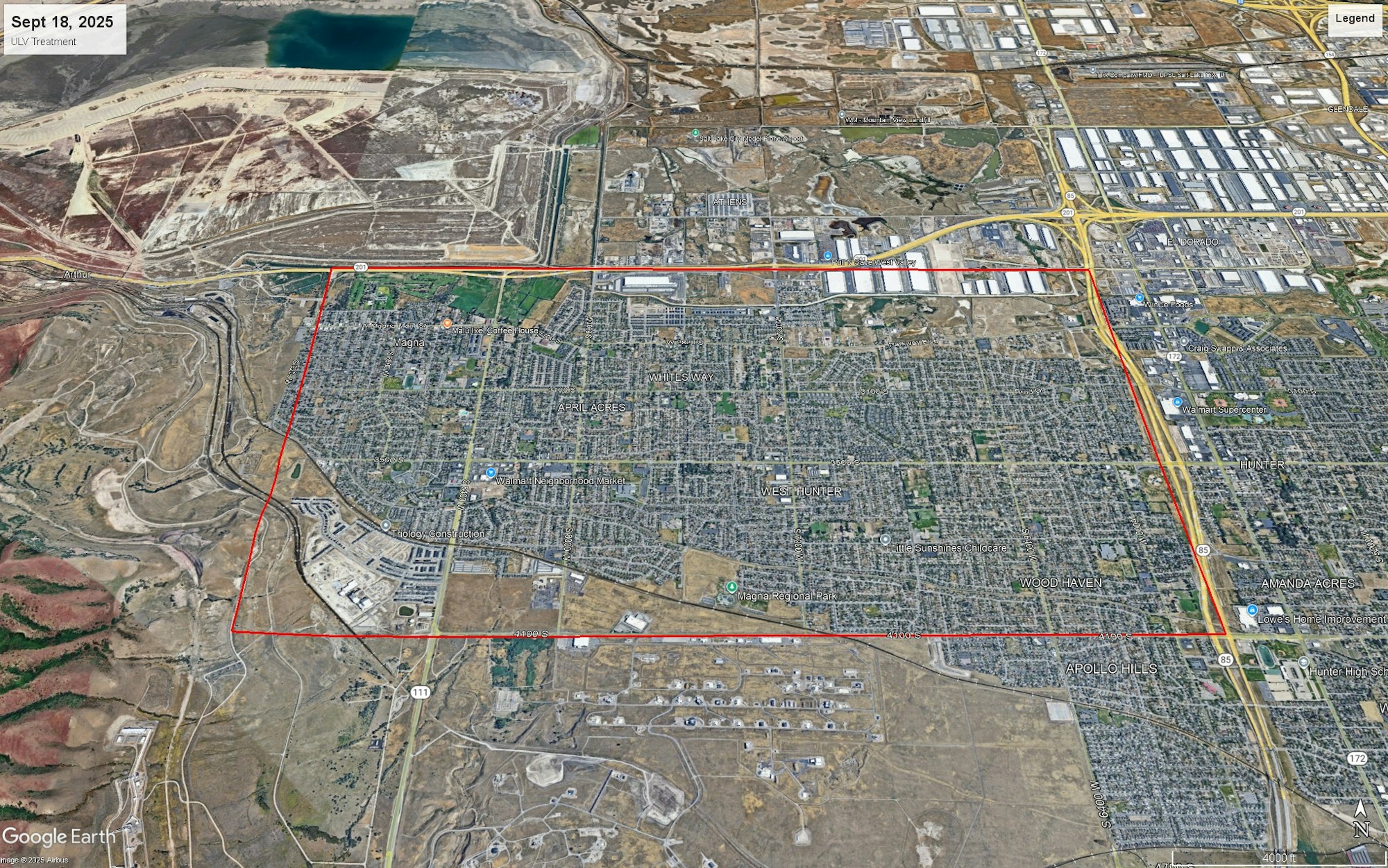 Aerial view of an urban area with labeled communities, surrounded by industrial and undeveloped land, bordered by red lines.
