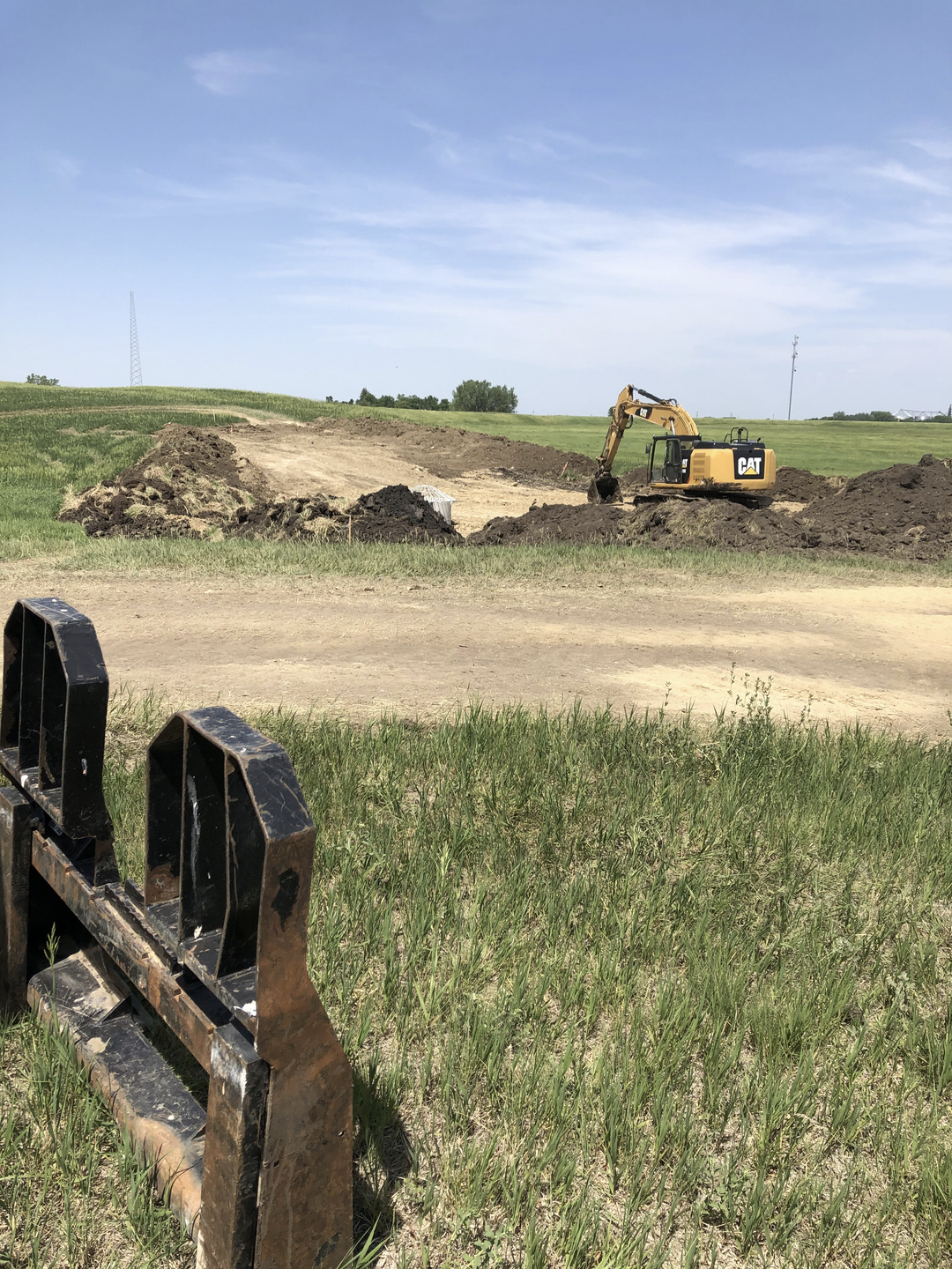 May contain: grass, plant, soil, outdoors, bulldozer, machine, nature, field, and grassland