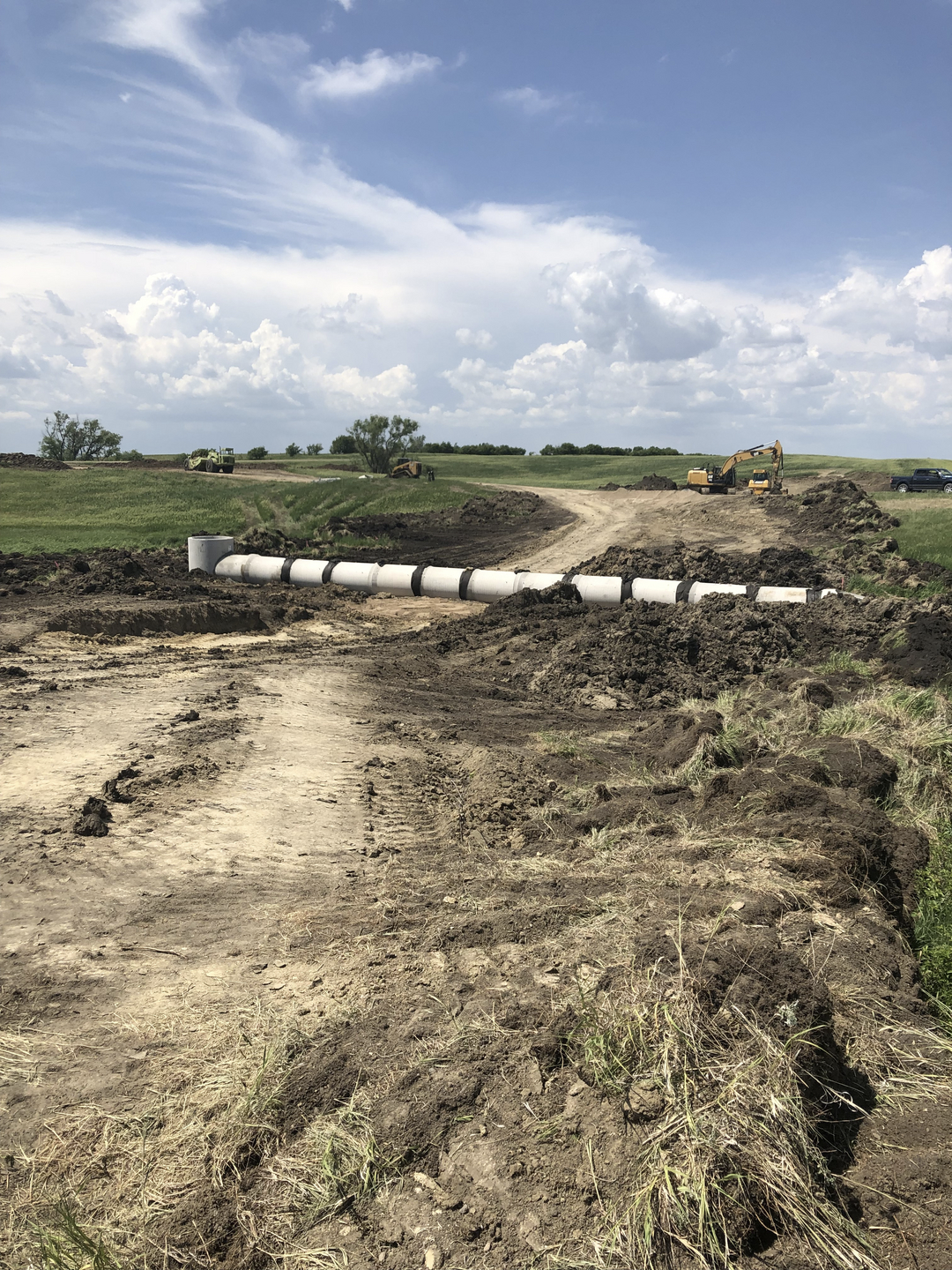 May contain: soil, ground, land, nature, outdoors, countryside, farm, field, pasture, rural, car, transportation, and vehicle