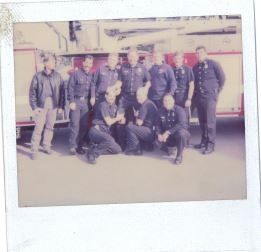A group of people in uniform posing in front of a fire truck.