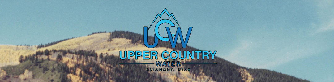 Logo for Upper Country Water, Altamont, Utah, on a mountain landscape background.