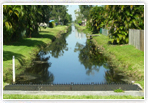 May contain: canal, outdoors, water, nature, pond, grass, plant, path, scenery, and towpath