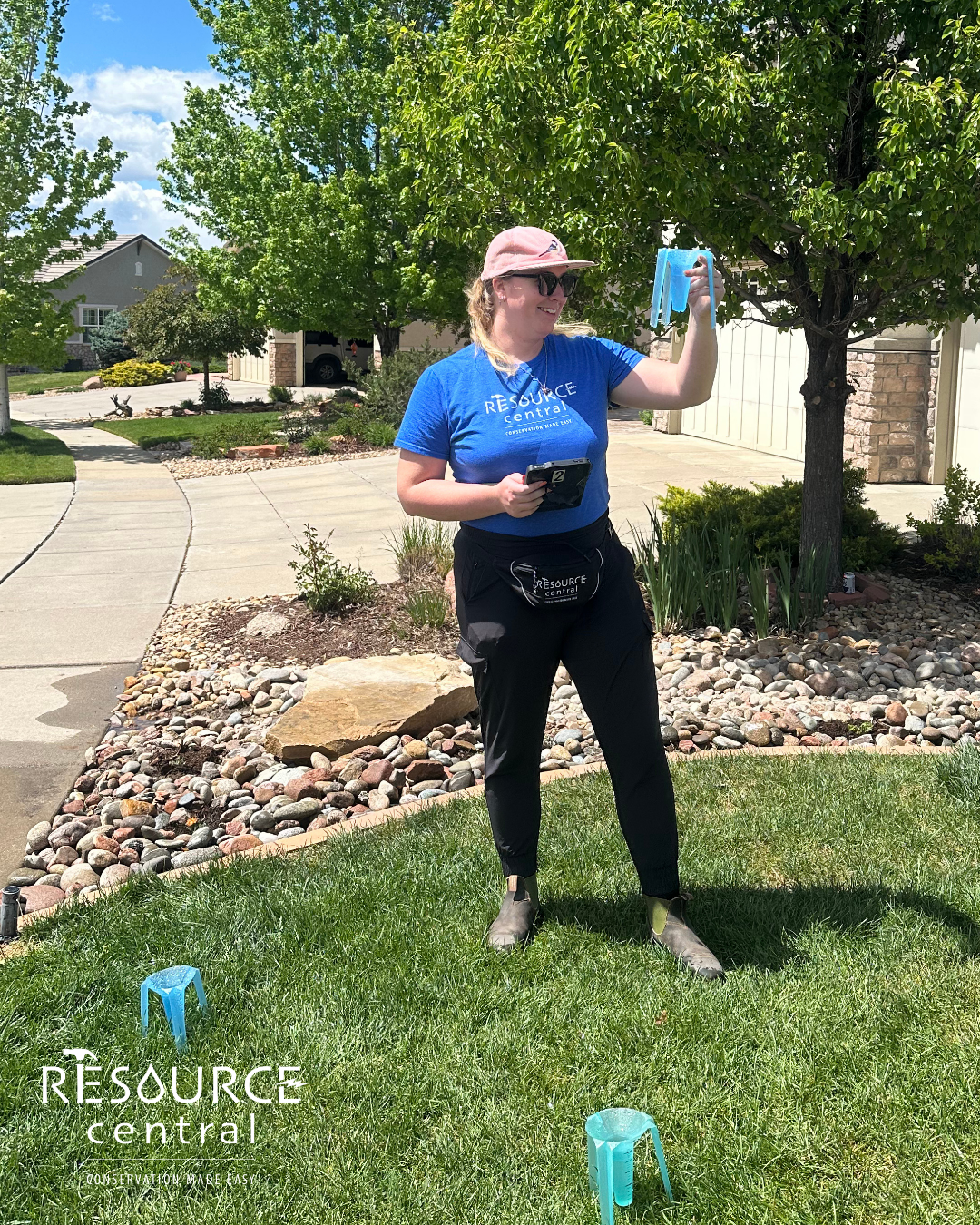 A person stands outside holding measuring cups, surrounded by greenery and a driveway, promoting conservation.