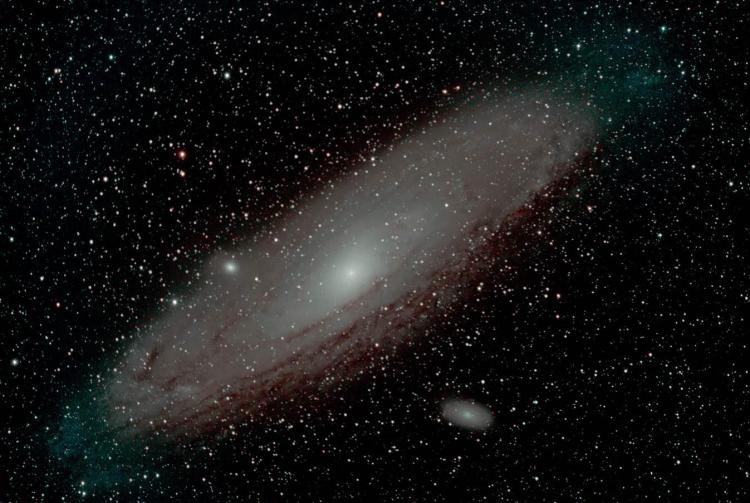 A spiral galaxy surrounded by stars against the backdrop of space.