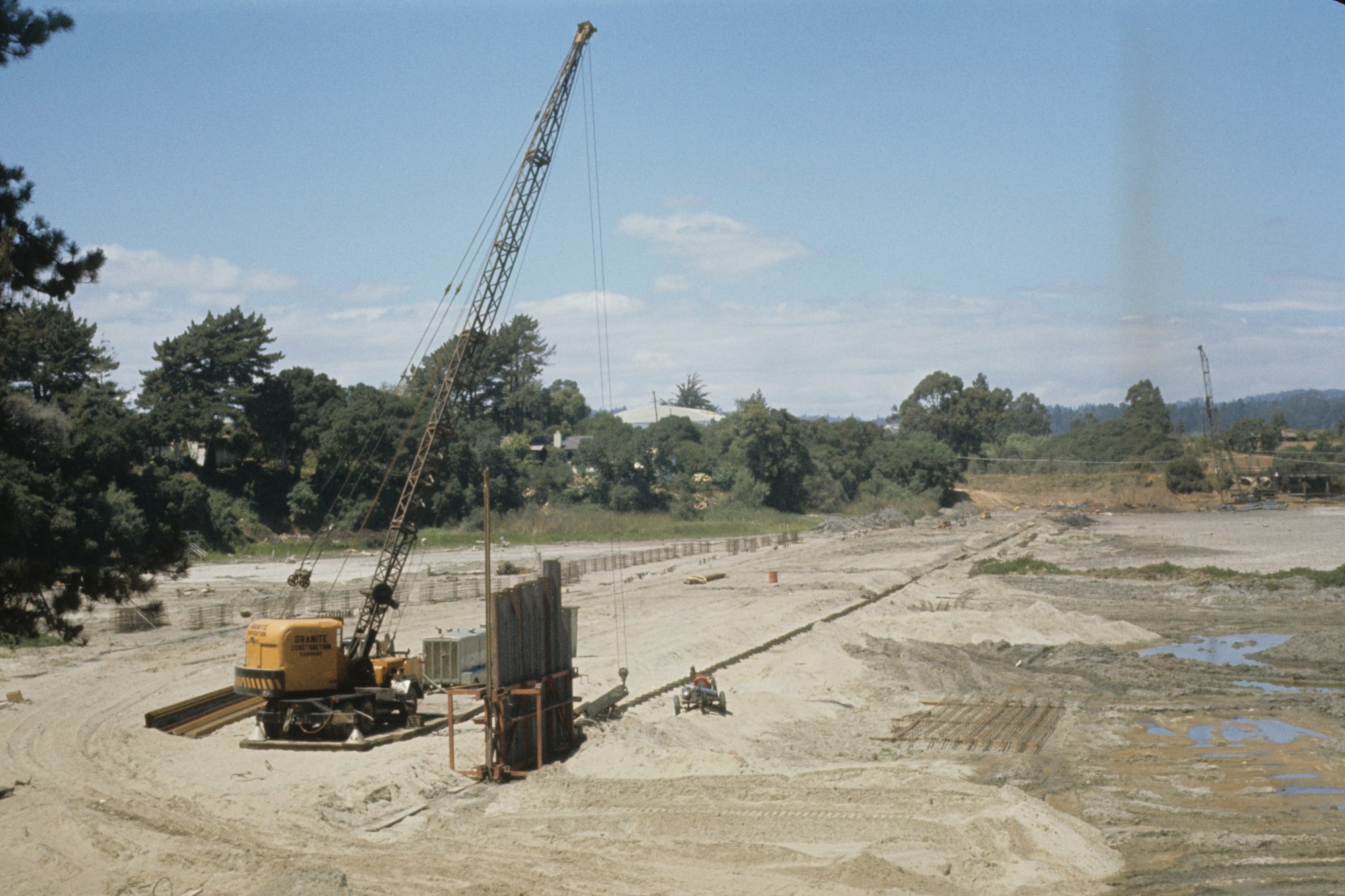 A construction site with a crane and groundwork in progress.