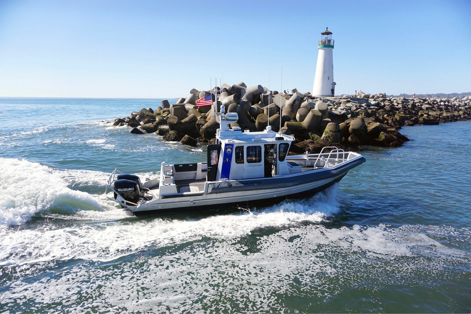 Patrol Boat Kinnamon transiting the harbor entrance channel, Walton Lighthouse in background.