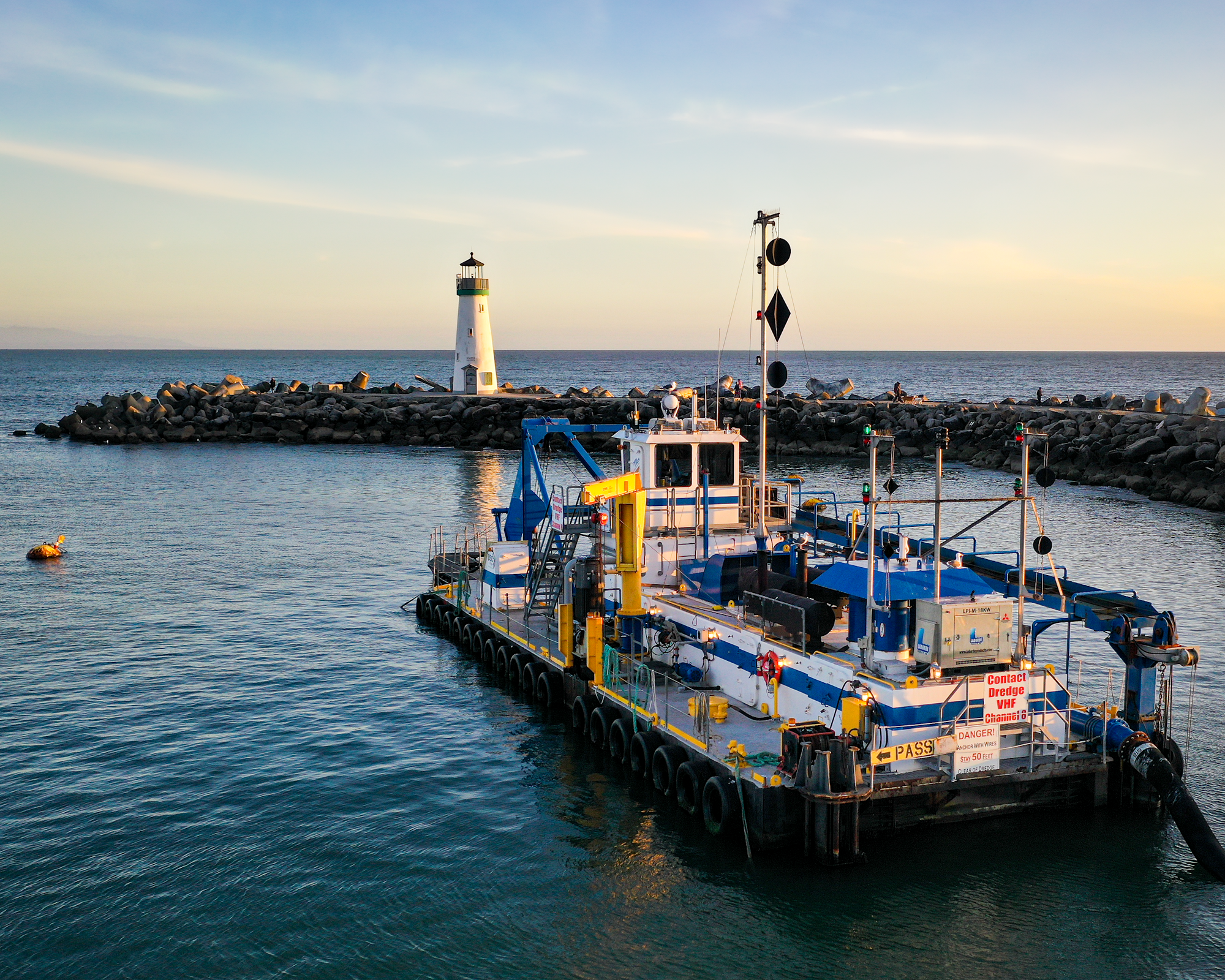 Picture of the dredge "Twin Lakes" in the entrance channel facing the Walton Lighthouse