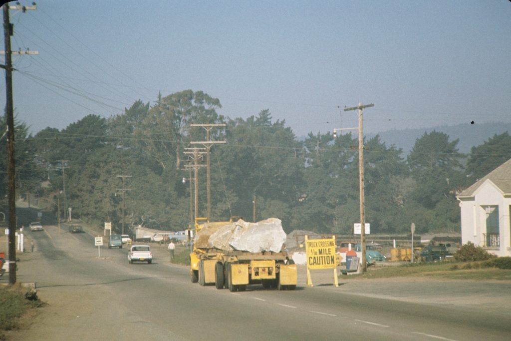 May contain: utility pole, city, road, street, urban, car, transportation, vehicle, person, machine, and wheel