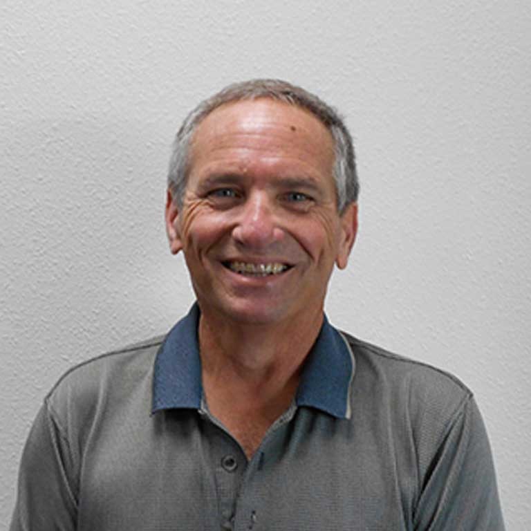 May contain: face, head, person, photography, portrait, happy, smile, adult, male, man, clothing, shirt, body part, and neck