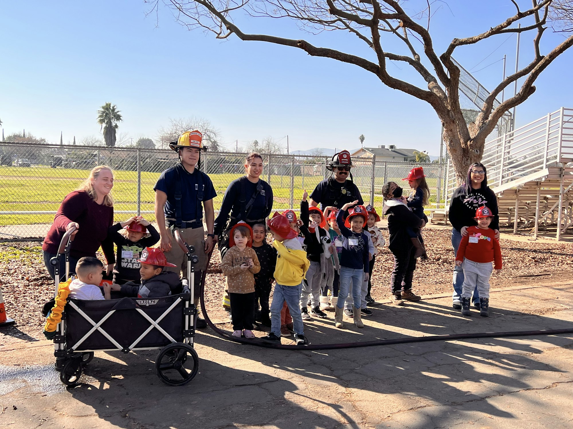 group of fire fighters with children