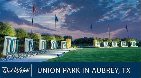 Entrance sign for Union Park in Aubrey, TX, with large letters and landscaped surroundings.