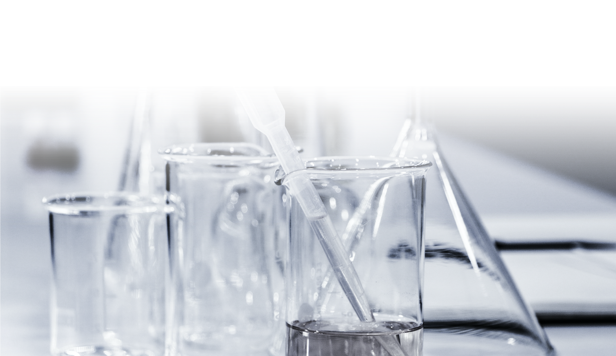 The image features various laboratory glassware, including beakers and a pipette, commonly used in scientific experiments.