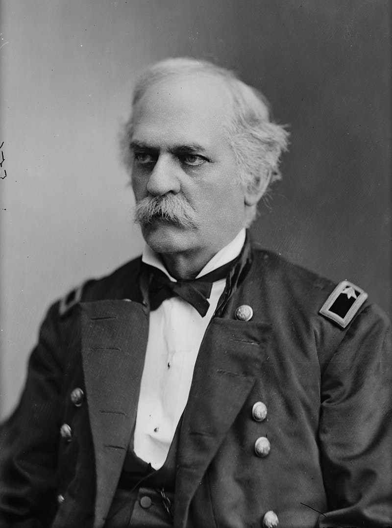A black and white portrait of a man in a military uniform with a mustache.