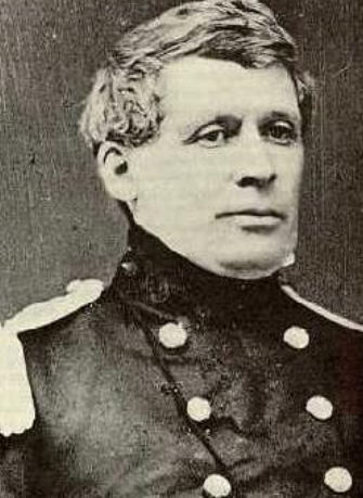 Vintage photo of a person in a uniform with buttons, high collar, and epaulettes.