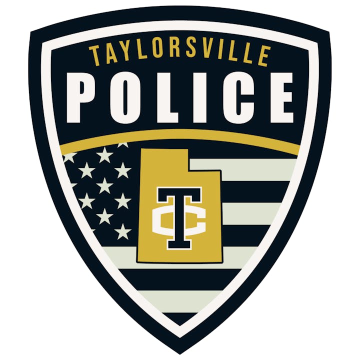 Taylorsville Police badge with US flag and state outline featuring "T" and "C" letters.
