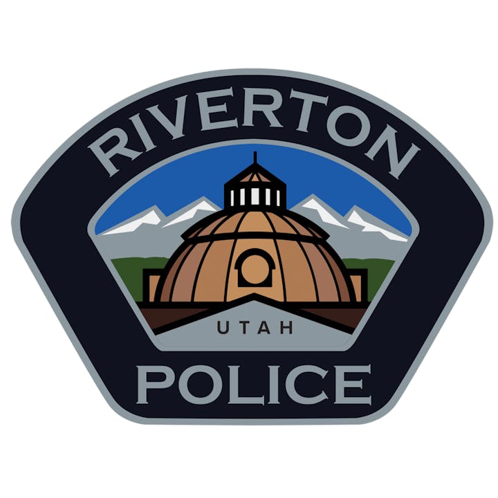 Riverton Police badge featuring a dome, mountains, and "Utah" beneath.