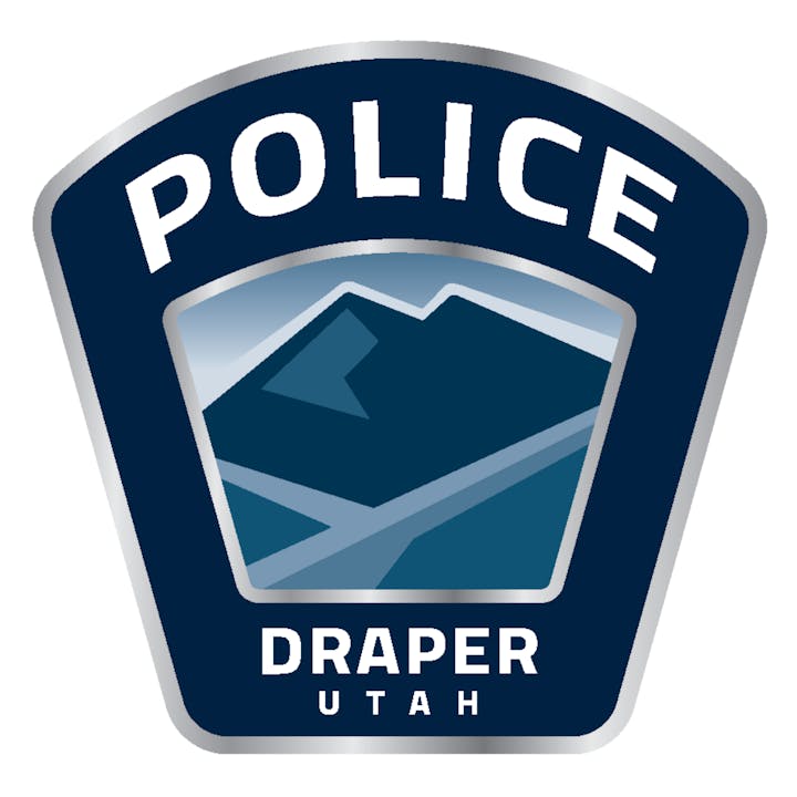 Police badge with a mountain design, labeled "Draper Utah."
