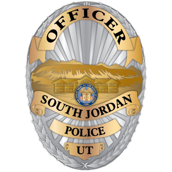 Police badge for South Jordan, UT with the state seal and mountain image.