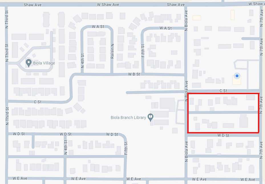 A map showing streets and buildings with a portion outlined in red.