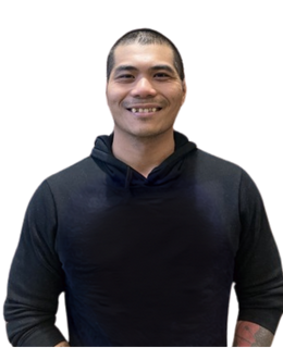Jimmy Douangdara, a EAPRD certified personal trainer, smiling, wearing a dark long-sleeve shirt with tattoos on the arms.