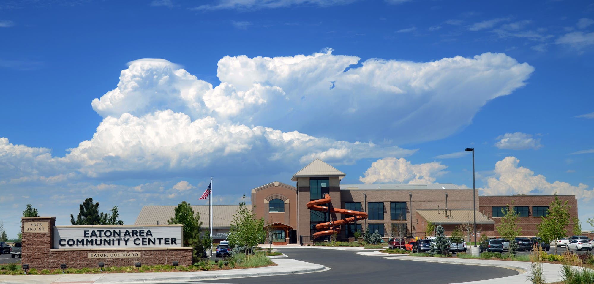 Eaton Area Community Center, Eaton, Colorado, with a building, parking lot, and an orange water slide outside.