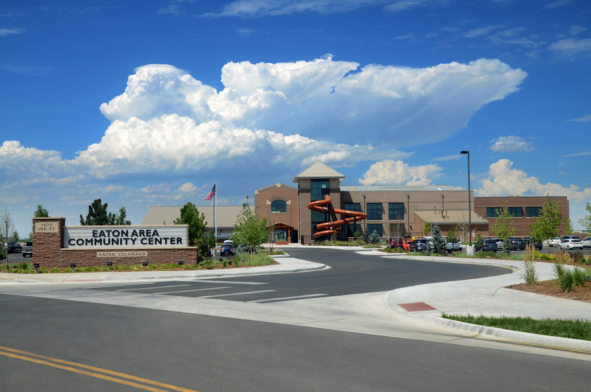 Eaton Area Community Center, Eaton, Colorado, with a building, parking lot, and an orange water slide outside.